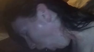 Slutty, Caucasian brunette is sucking a big, black dick in the middle of the night