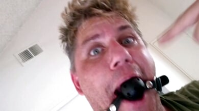 Bound male submits to strapon domination in bedroom role reversal
