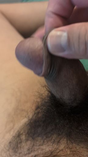 Playing with the foreskin of my brown uncut cock.