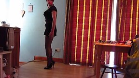 Wearing a sexy short black dress niylon tights high heels