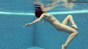 ”Charming petite teen wearing charming clothes underwater”