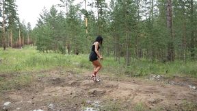 Hot girl in high-heeled boots smoking and walking on sand and falling through sand