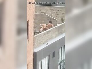 Lesbian strap-on on rooftop