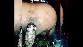 Slutty transvestite wallowing in the mud, putting bottles up her ass