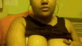 Chubby mulatto chick sucks her fingers and caresses her large titties
