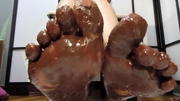 My feet with varnished nails, all covered with chocolate cream