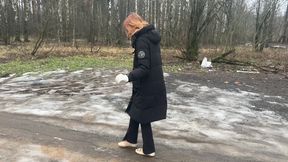 A girl walks in ballet flats on a very bad road where there is slippery ice and slippery mud, her ballet flats slip on such a road and get very dirty