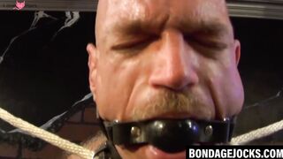 Muscular hunk endures bondage with pins in his chest