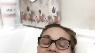 MILF is moaning for the camera while masturbating in the bathtub