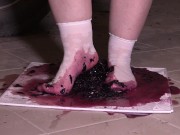 Plump legs in white socks mercilessly trample grapes. Crush fetish