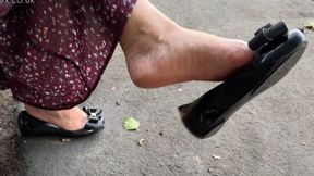 Ballet flats Shoeplay and dangling sitting on a bench