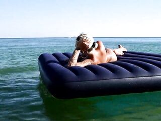 I spy on the beach as a beauty with large melons sunbathes in front of the public and dolphins