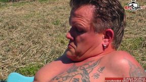 Mature woman seduces a farmer to have sex next to the tractor in a field