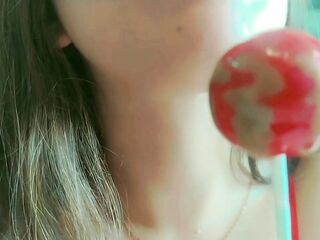 Just a cute and wicked hotty sucking lollipops, begging dad to cum on her throat . Throat close up