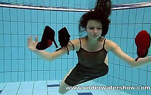 She enjoys swimming with her big boobs in the pool