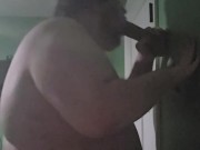 Fat male in chastity sucking off 12 inch dildo
