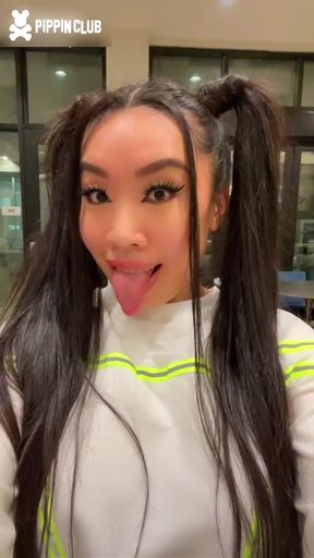 Asian girl with pigtails and tongue out