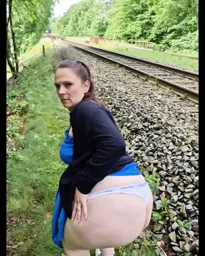 German MILF fucks her pregnant self outside in the field