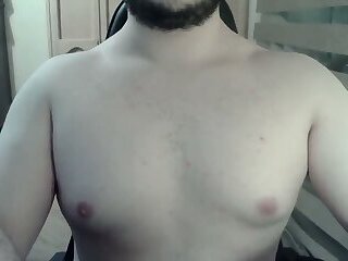 Muscular jock flexes his muscles on can
