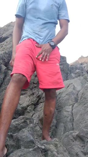 Man in red shorts on rocky terrain