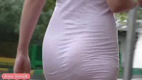 Teasing in a white see-through mini dress