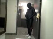 skeleton faced white socked black morphman in front of hotel room