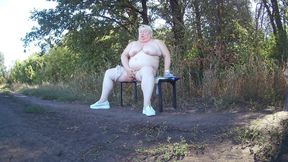 Mother-in-law in the park undresses and masturbates to orgasm on a bench