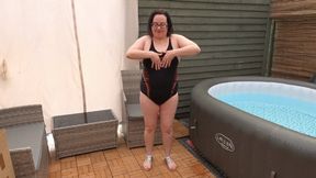 Tarty Wife with big breasts posing in sexy black swimsuit and sandals