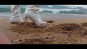 Pretty girl in long heels walks on a snowy beach