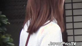 ”Japanese girl takes off her dress to piss outside in public”