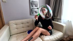 Blowing giant bubbles in a short skirt