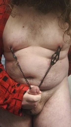 Fat boy rubbing cock with nipple clamps on