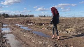 A girl in high-heeled shoes walked into a very dirty area where her shoes literally sank into the mud and got stuck in it (reissue)