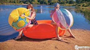 Q886 Cosette and Stashia blow two big beach balls on a lake - 1080p