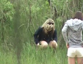 Blonde white Russian girl in the high grass squats and pisses