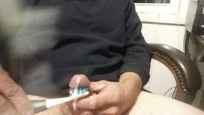 Cumming with toothbrush