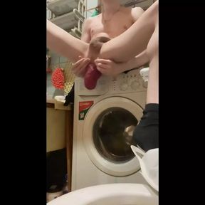 A young sexy guy sits with his legs spread in his bathroom and plays with his huge anal prolapse