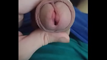 The guy shows his penis head in close-up, jerks off his penis