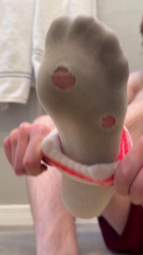 Tiny twink gets a footjob from a dirty feet fan