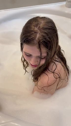 tender beautiful bitch in foam in the bathroom touches her cute young pussy