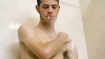 Bearded twink Bleu smokes and strokes his cock in the shower