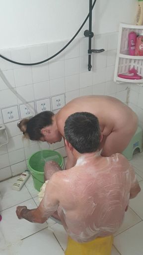 Old man bathing with his young girlfriend, Turkish couple in their natural home life.
