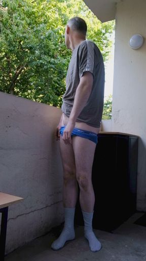Horny wanker outside on balcony wanks flaccid uncut cock as he strips gets erect penis shows asshole  proudly exposing himself