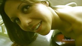 Skinny British brunette posing in the kitchen
