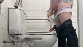 in the hospital toilets, a guy pisses into a cup for a urine sample, then gets horny, jerks-off and cums