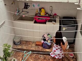 The neighbor is watched washing clothes by her neighbor