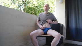 Man undressing outside on the balcony wanks his soft hair cock becoming erect as his strips