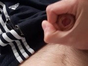 young chav guy in adidas sweatpants jerks off his cock and huge cums all over himself