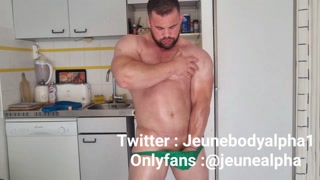 bodybuilder with oiled body jerks off and flexes