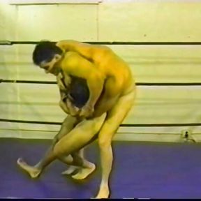 Two fit wrestlers fight naked in a boxing rink